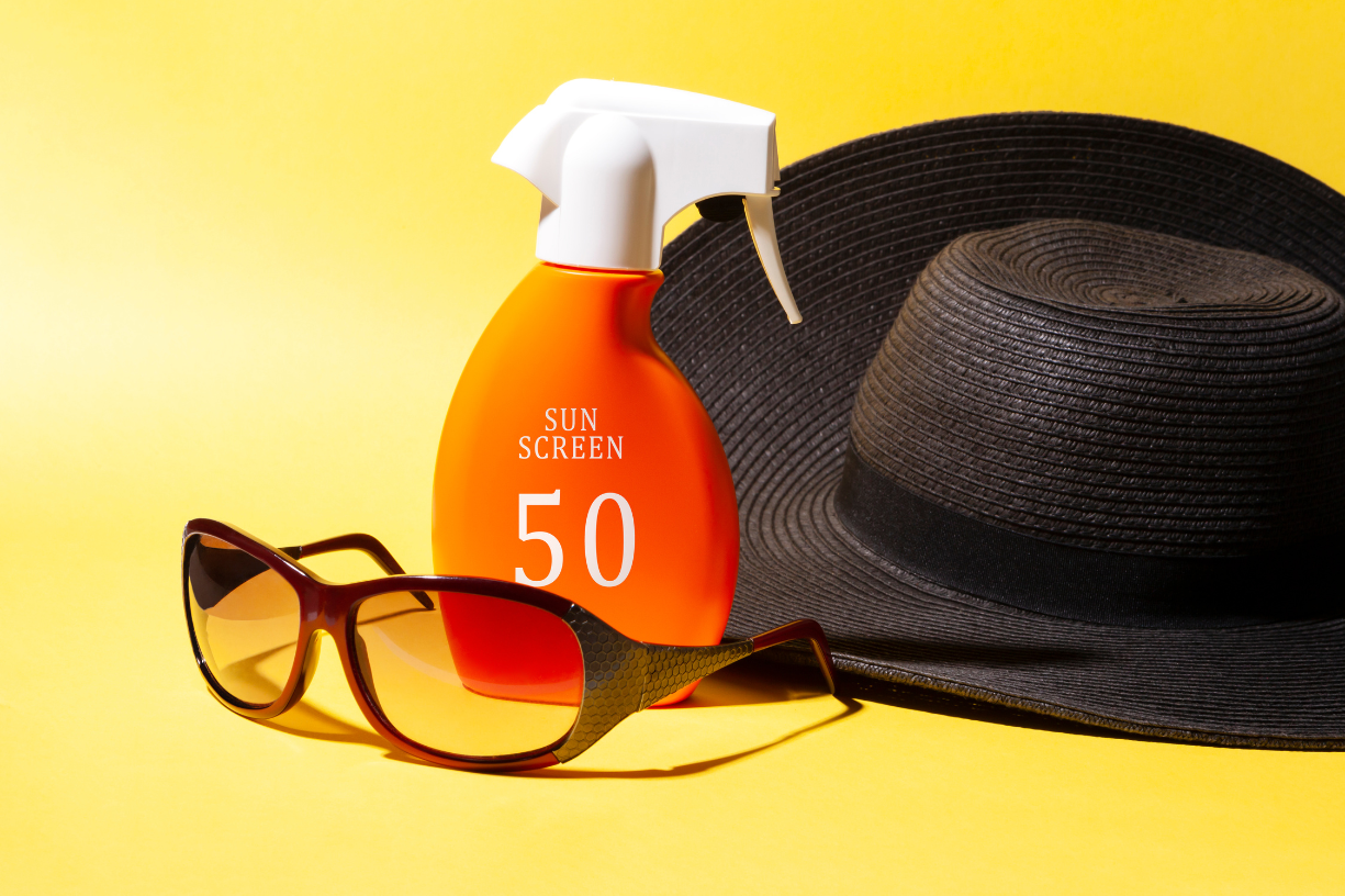 sunglasses, sunblock, sun hat, yellow background