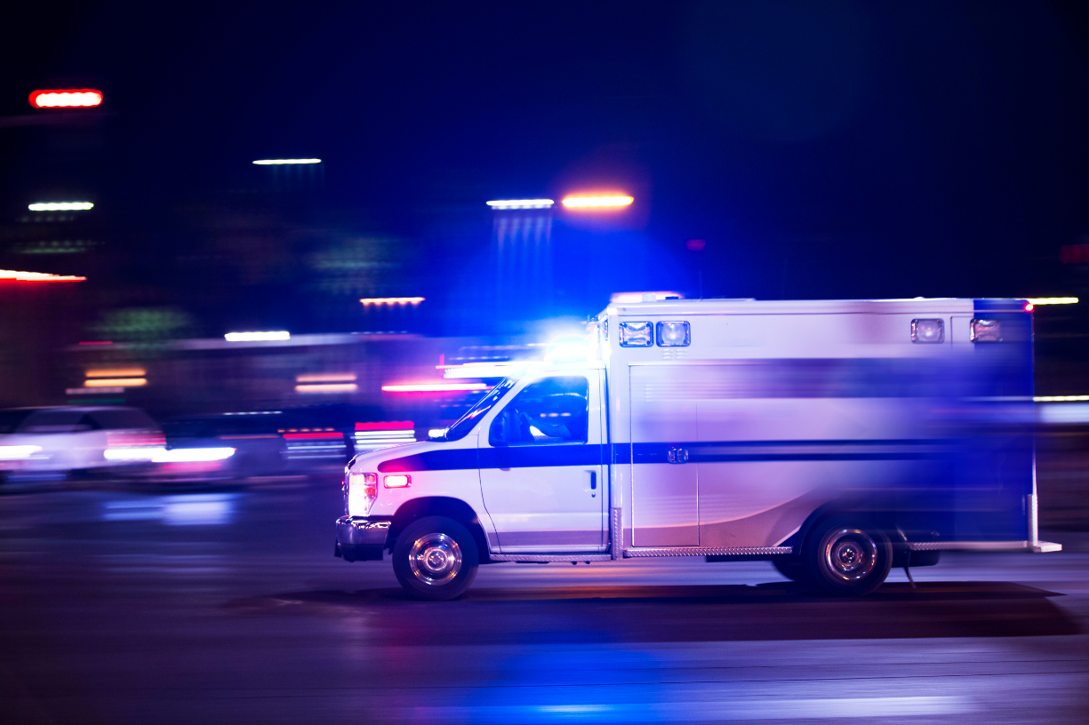 ambulance with lights and sirens after dispatched to a 911 call